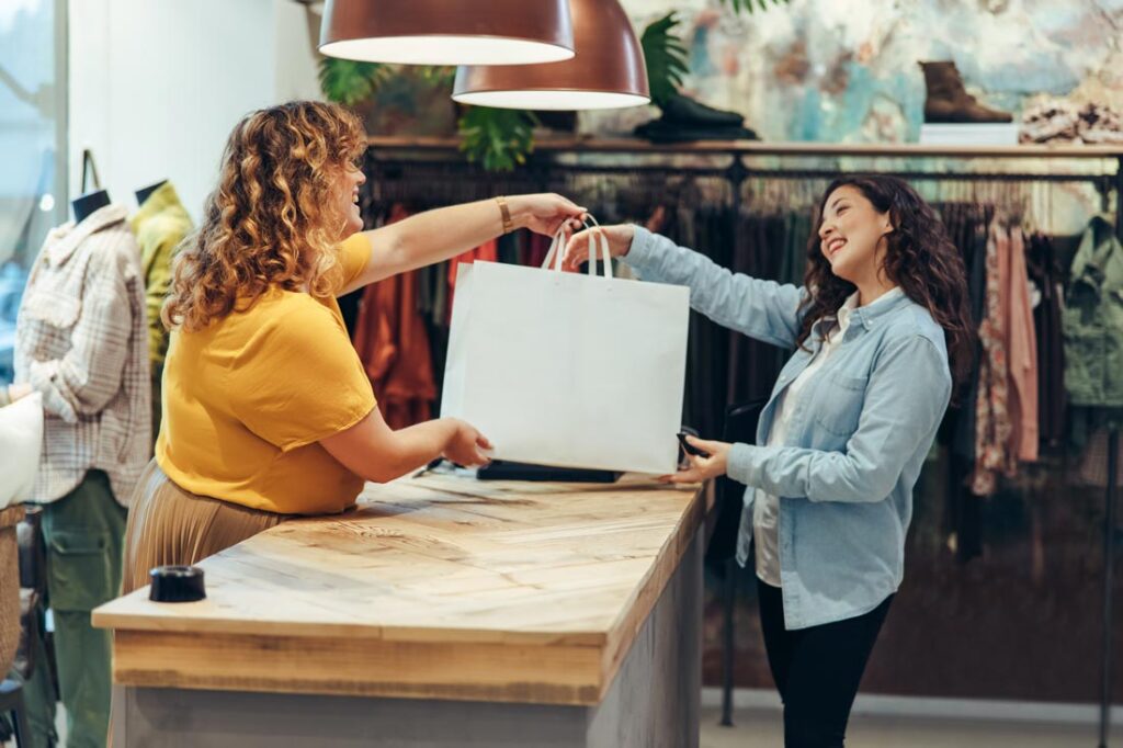 woman buying clothing in store