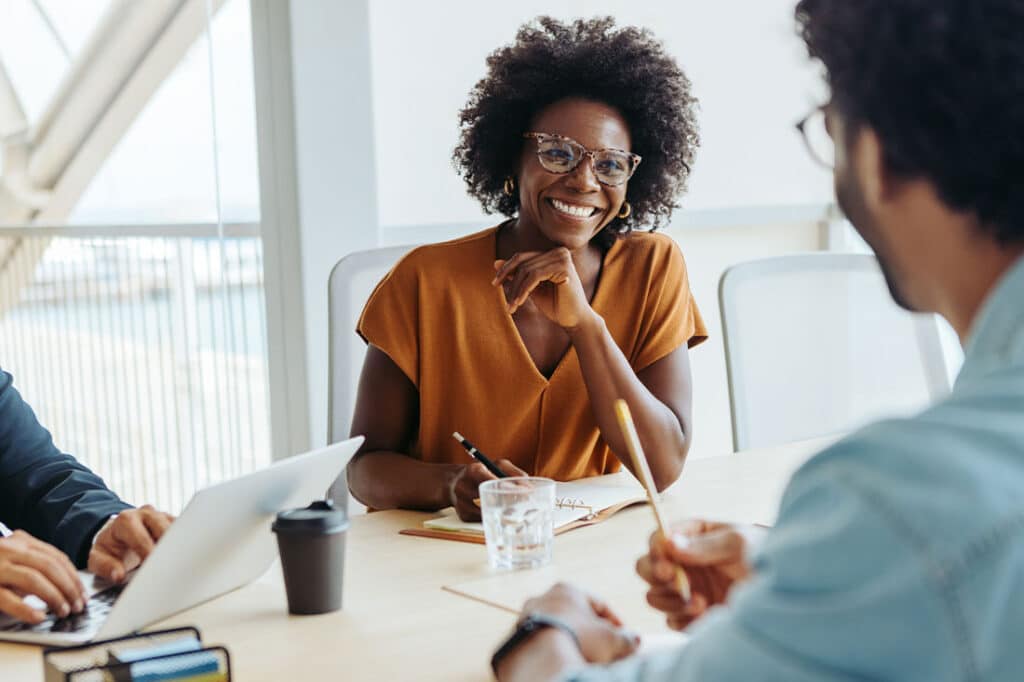 Group of professionals engages in a collaborative and creative brainstorming session in a modern boardroom