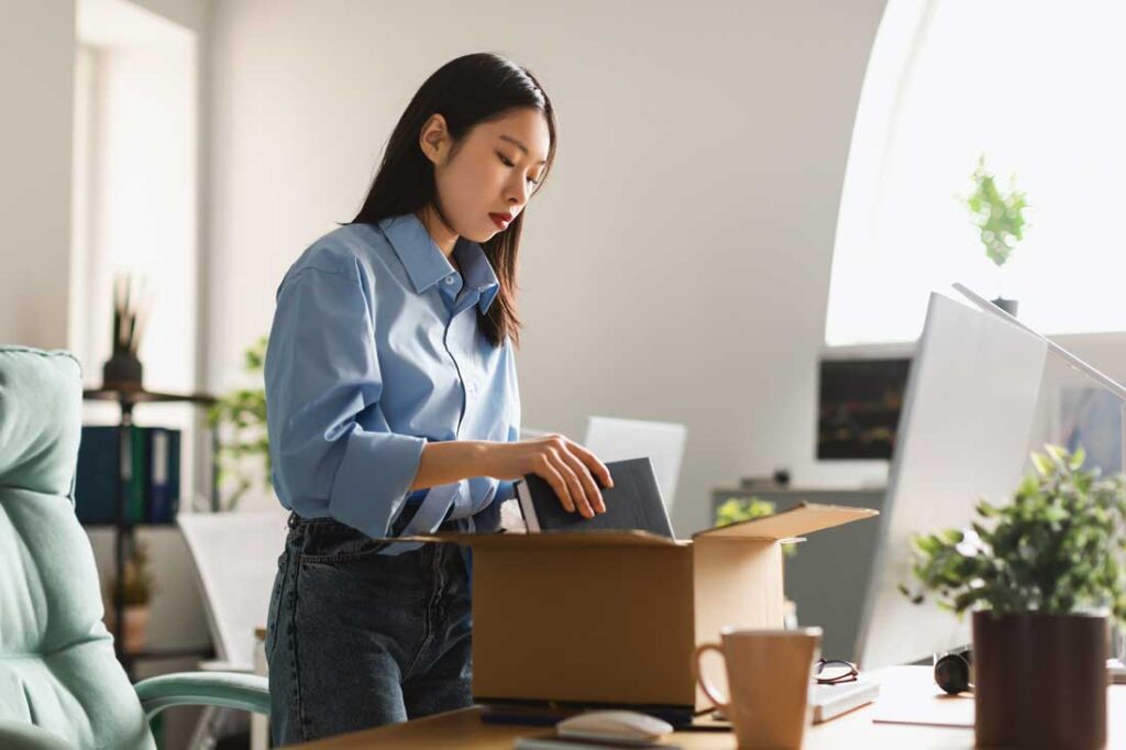 woman packing personal items after being fired