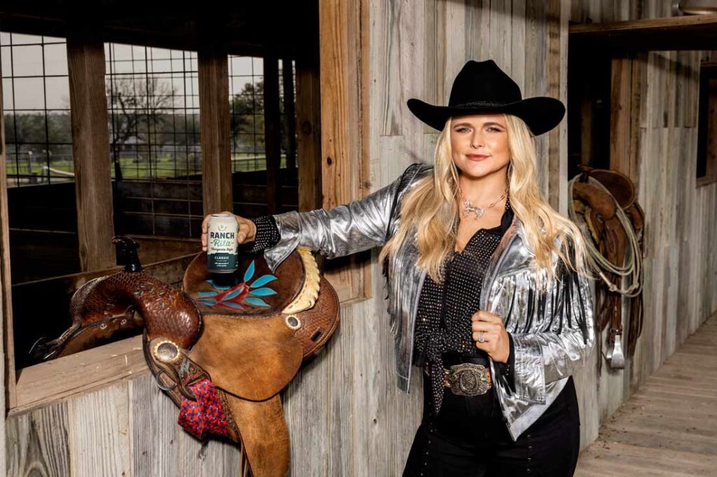 Miranda Lambert holding a can of Lone River in a barn