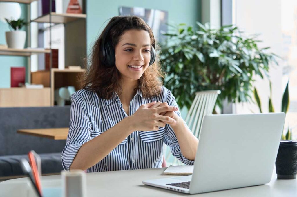 young neurodiverse employee wearing headphones as a workplace accommodation