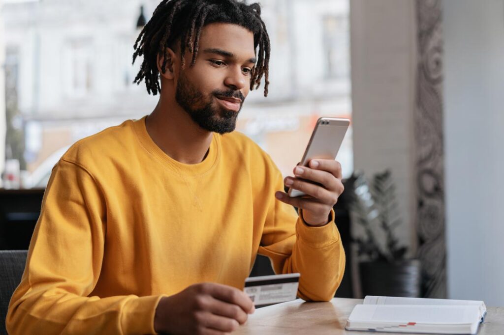 millennial man researching balance transfer cards