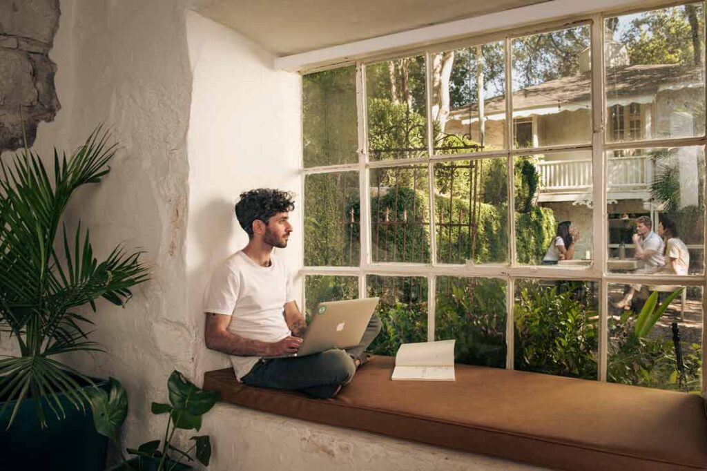 A Millbrook Companies employee working from a window seat