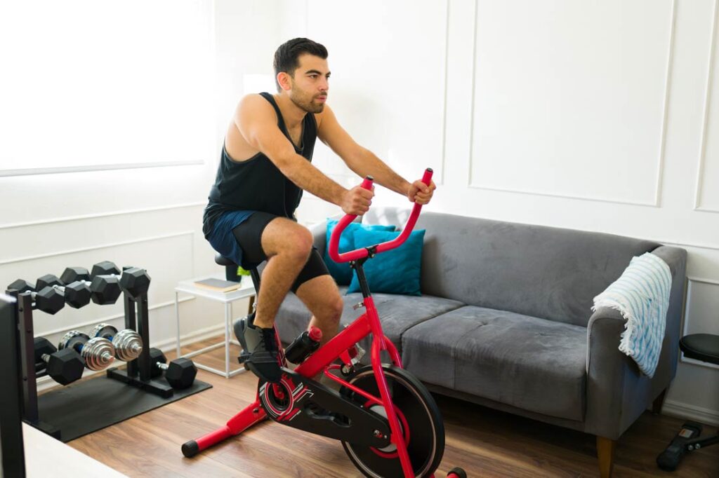 man using exercise equipment at home because of wellness perk at work