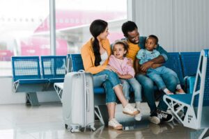 parents in airport traveling with kids