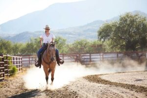 woman horseback riding at Miraval Resort & Spa, a wellness travel destination