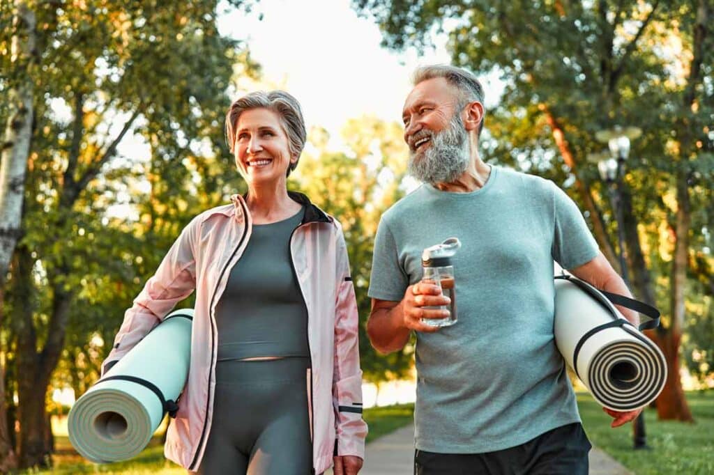 Happy older couple outdoors doing their self care routine