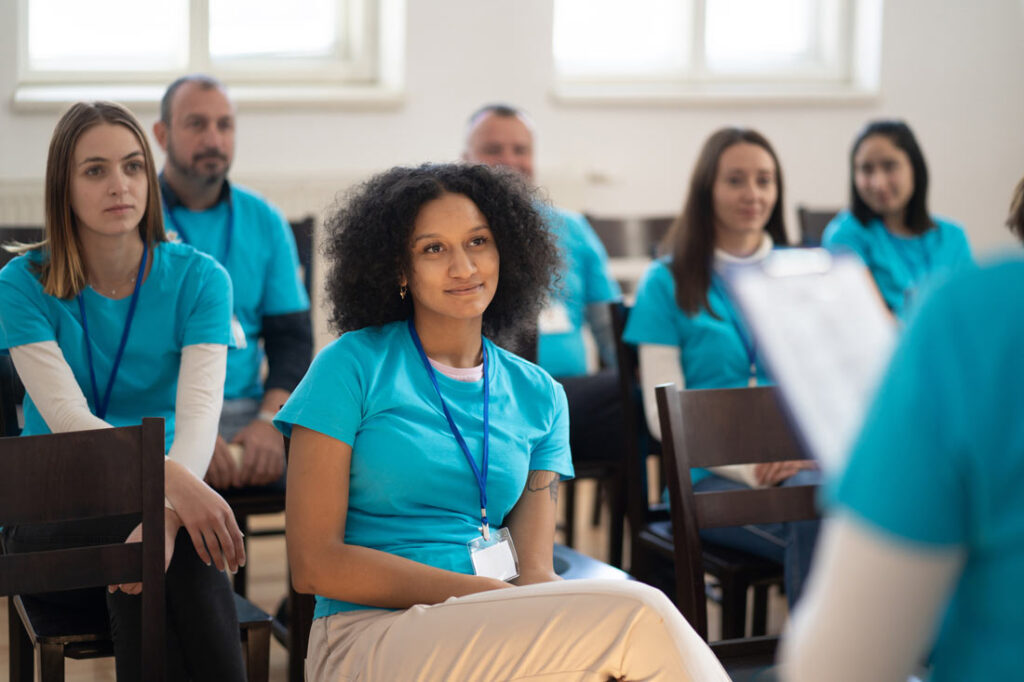 Several hospital employees sitting in a room for training that's intended to increase employee buy-in