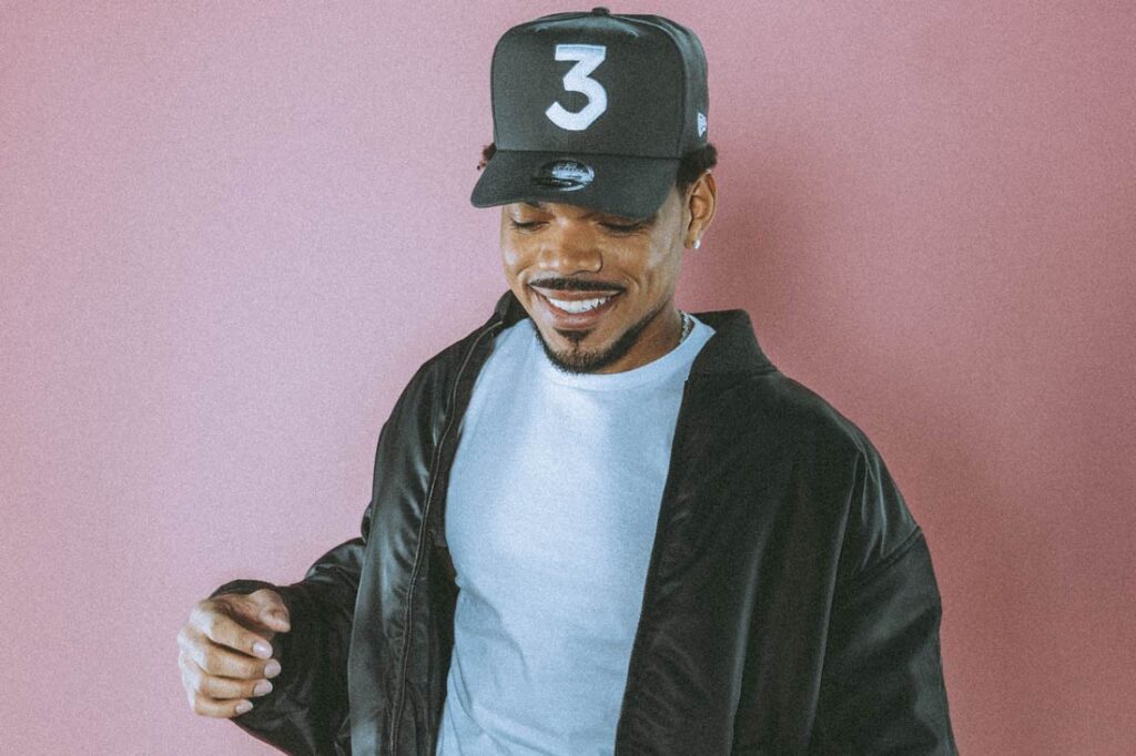 Chance the Rapper looking down and smiling