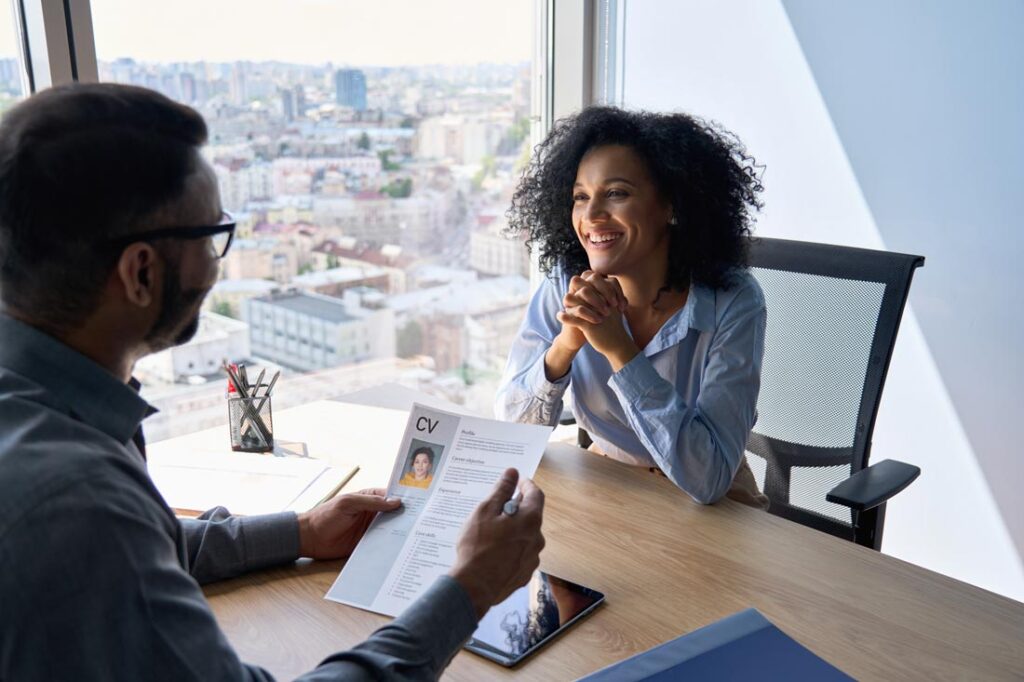 A young Black woman interviewing for a job and a man hiring for emotional intelligence