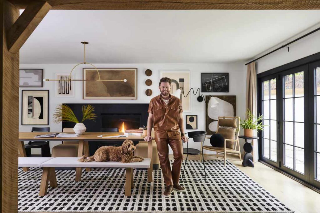 Bobby Berk standing in a well-appointed living room