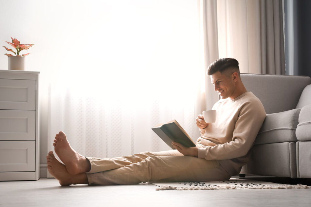 man reading a personal development book