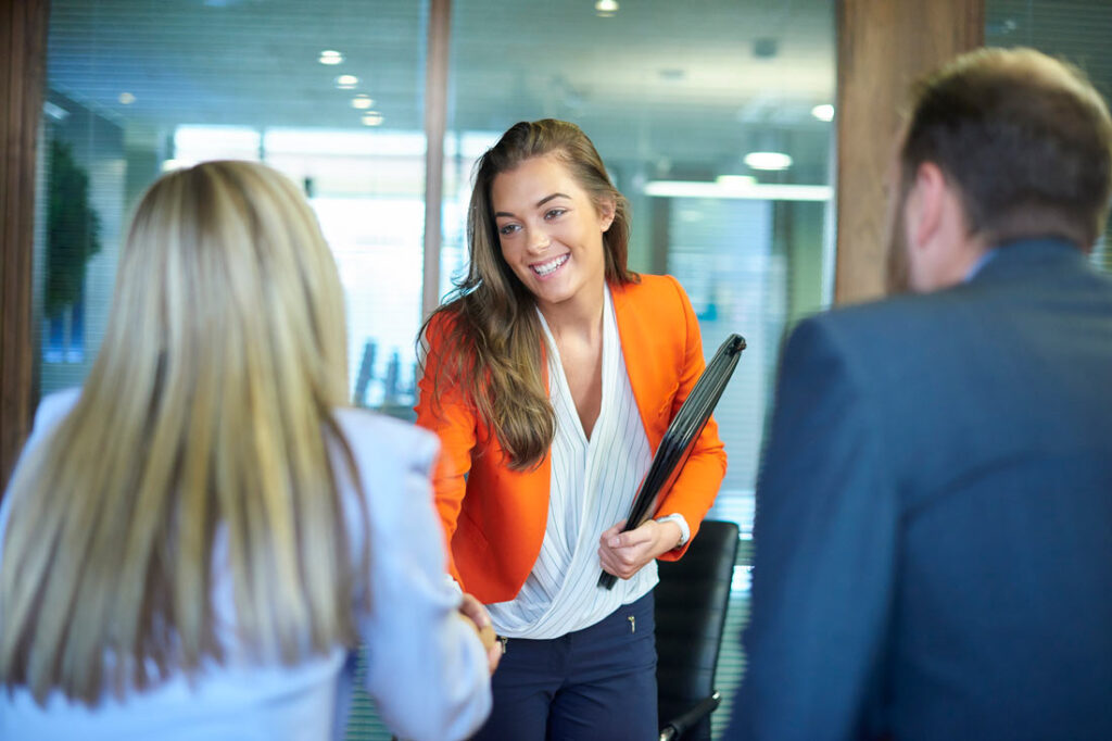 young job seeker shaking hands with interviewers during the September Surge