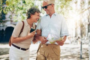 A mature couple on vacation and laughing because they had an ESOP retirement plan