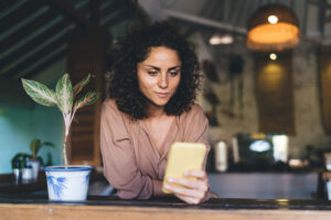 woman researching different types of retirement plans on her phone