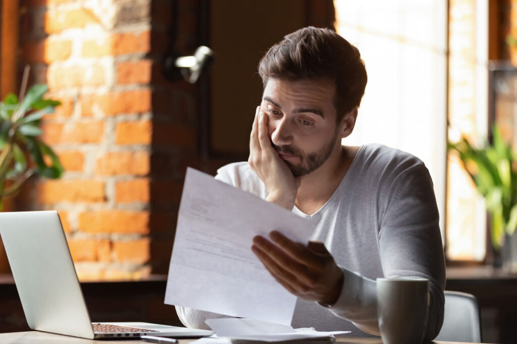 Confused man at his desk who needs ADHD techniques to focus