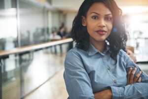 Black business woman who is an industry disrupter wearing a blue collared shirt