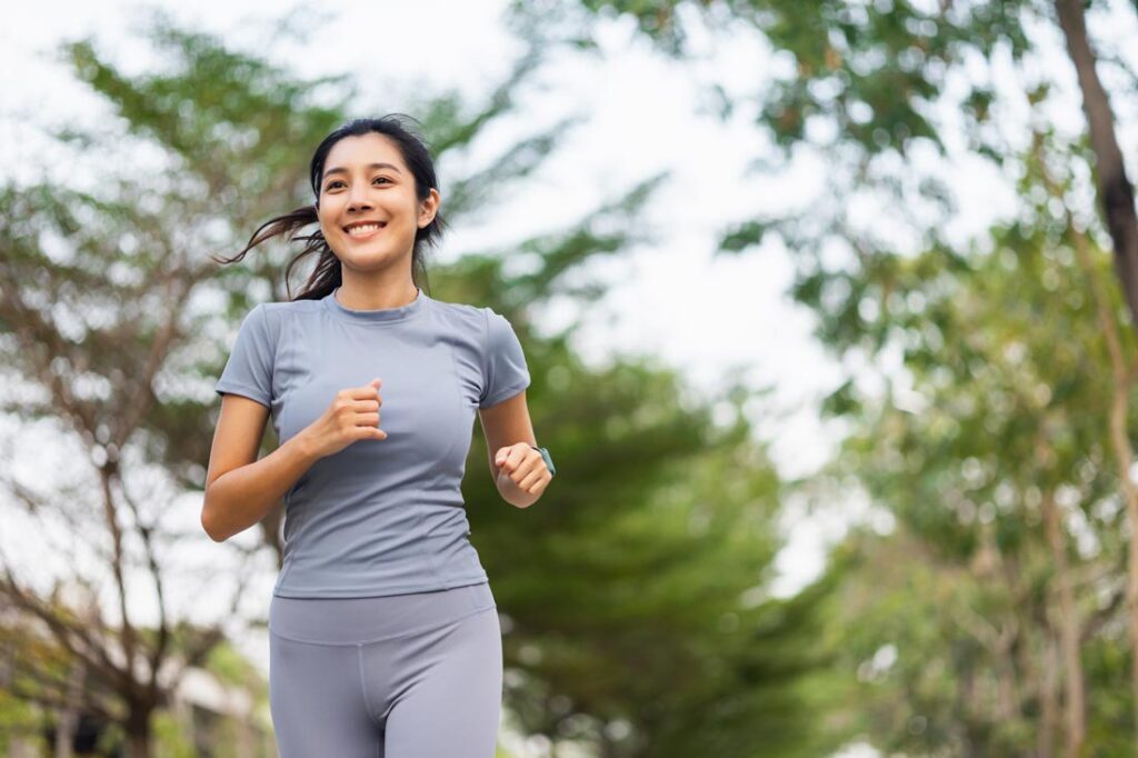 Asian woman running showing how marathon training builds resilience