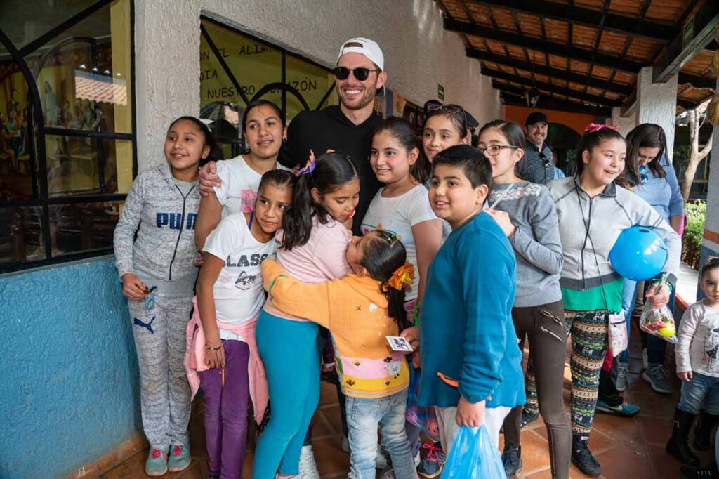 Socorro Tequila owner surrounded by school children from Jalisco, Mexico after donating cases of water