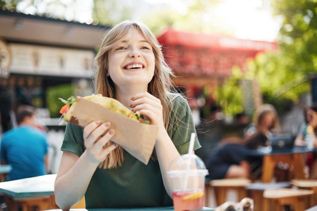 Young blonde woman taking her lunch break working from home