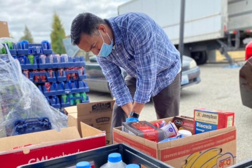 A man packing food for The Making a Difference Foundation's Eloise’s Cooking Pot food bank