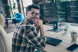 Man sitting in front of his computer learning how to vet an AI consultant