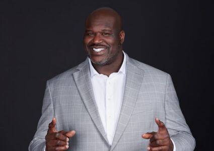 Shaquille O'Neal pointing and smiling because he's one of the most charitable celebrities SUCCESS magazine has featured on their cover