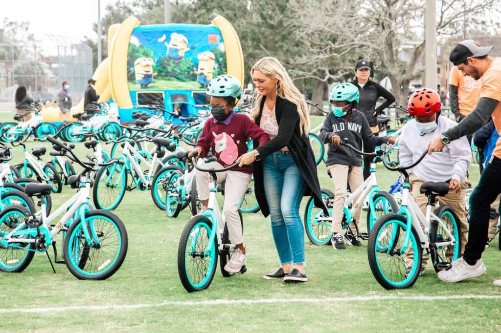 Katie Blomquist founder of the Going Places nonprofit helping a young girl learn to ride a bike