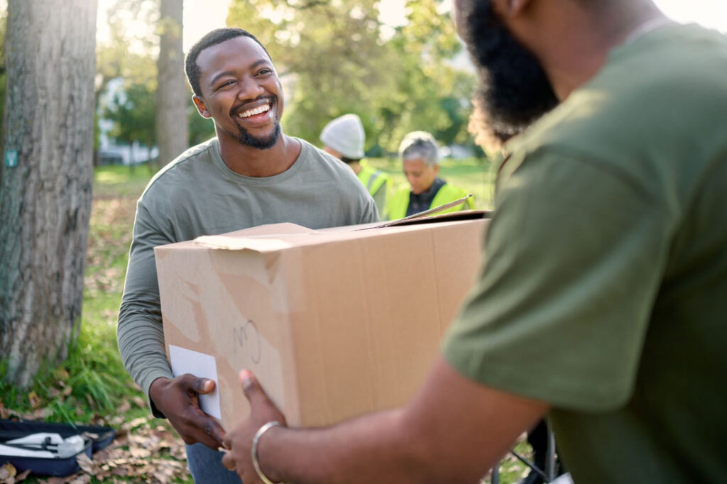 Smiling man volunteering and learning how to list volunteer experience on his resume