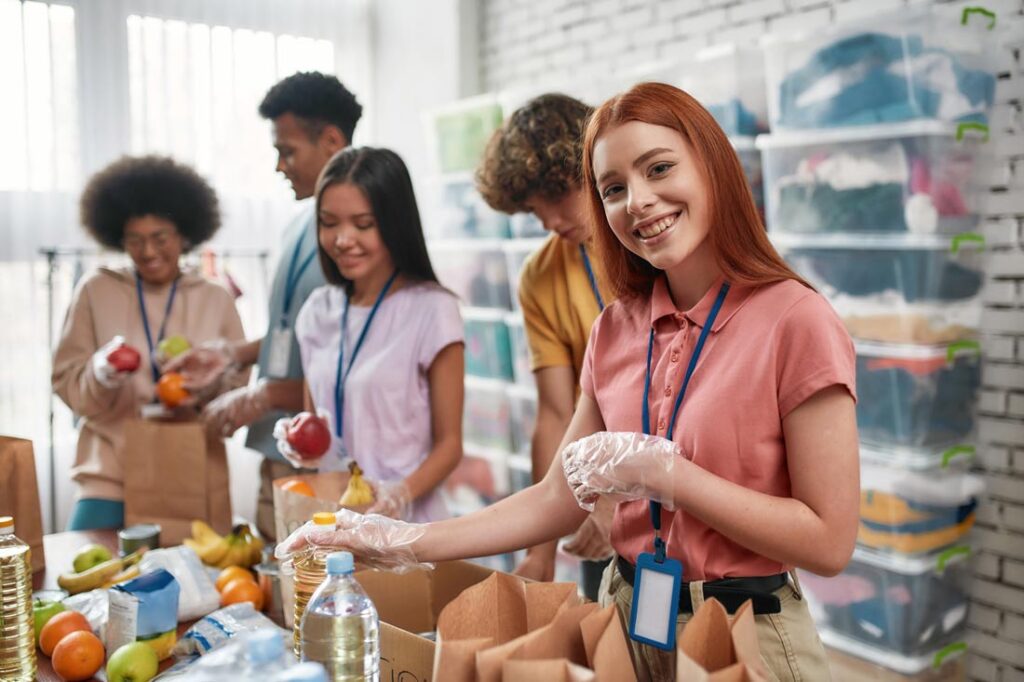 Teenagers volunteering at a food pantry to show one of the many volunteer opportunities for teens