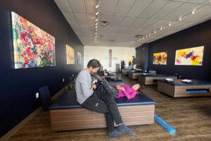 StretchLab flexologist uses technology to stretch a client