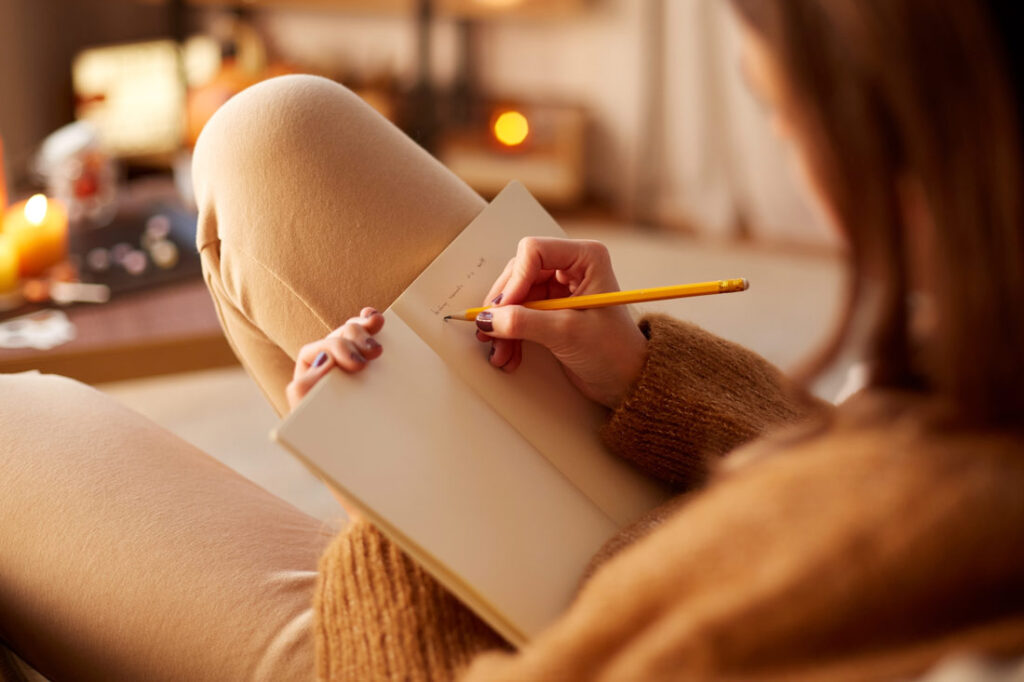 Closeup of a woman doing gratitude journal prompts