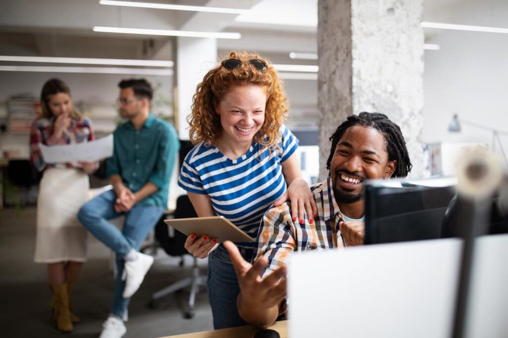 Two marketers creating human centric marketing content and smiling