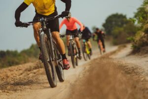 Cyclists riding on a dirt path learning life and business lessons from adventure racing