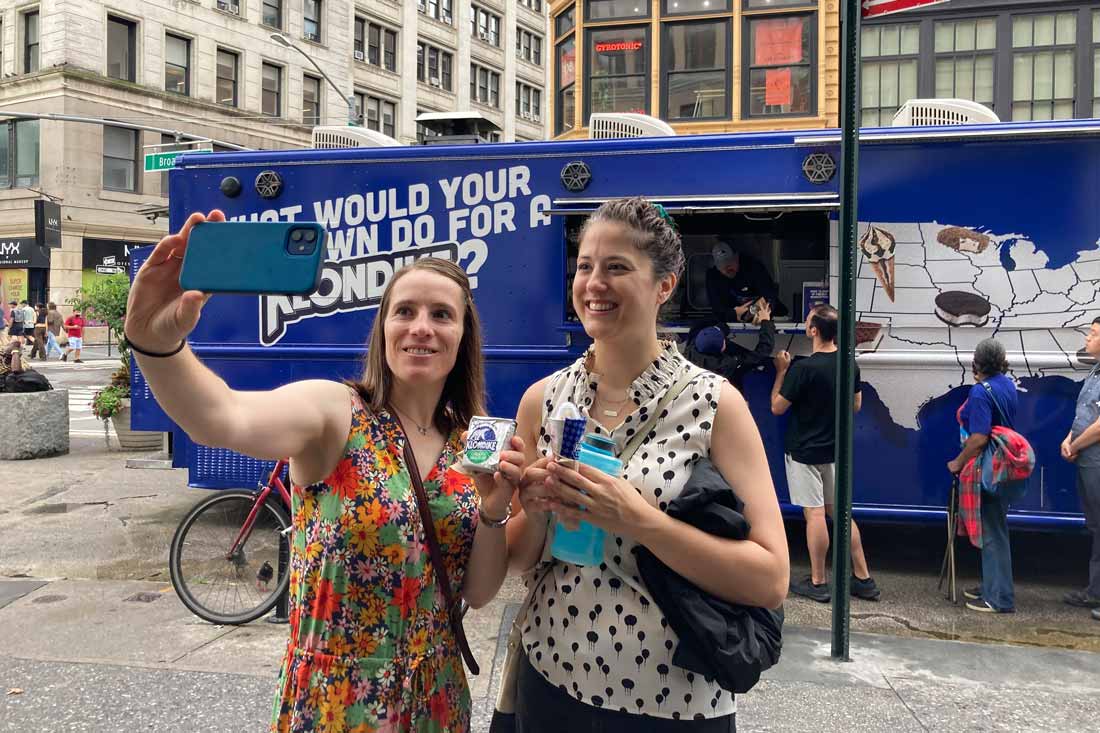 Two women taking a selfie in front a truck giving out free Klondike bars exemplifying how grassroots marketing has evolved