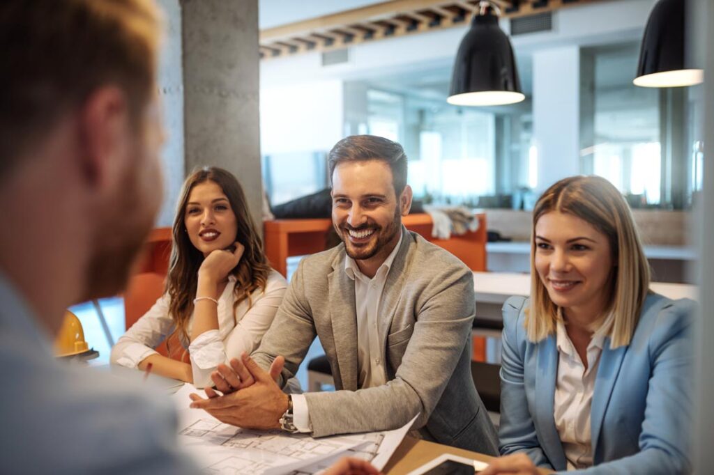 Three people interviewing a fourth for a job representing the different interview styles