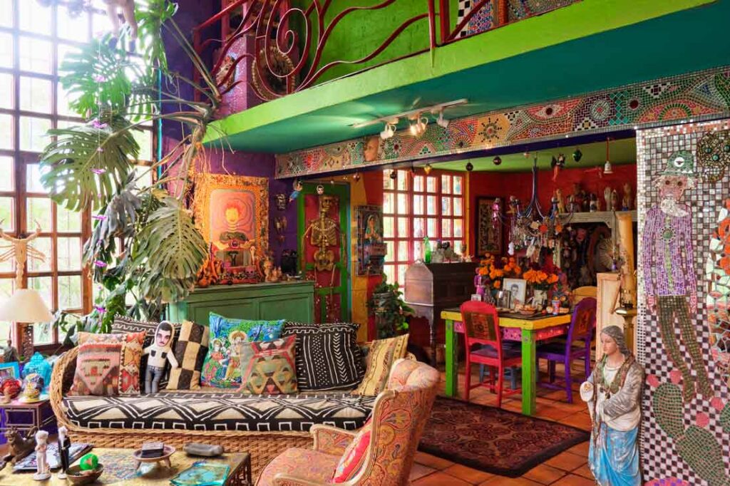 Living room with lots of colors and tchotchkes, an example of maximalist interior design