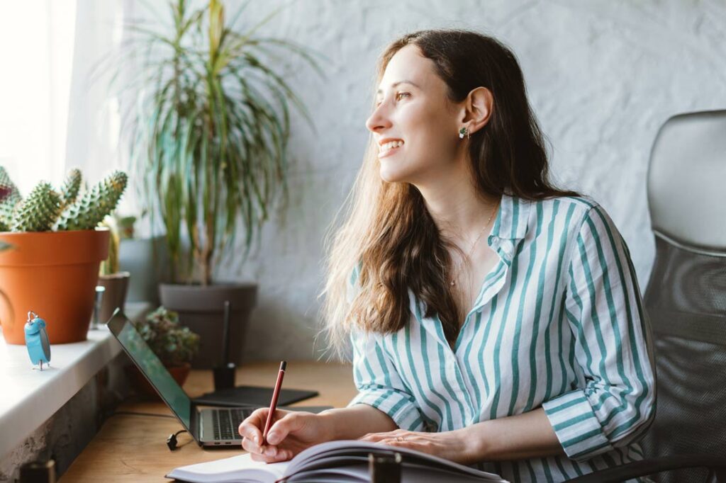 Woman sitting at her desk creating a time management matrix