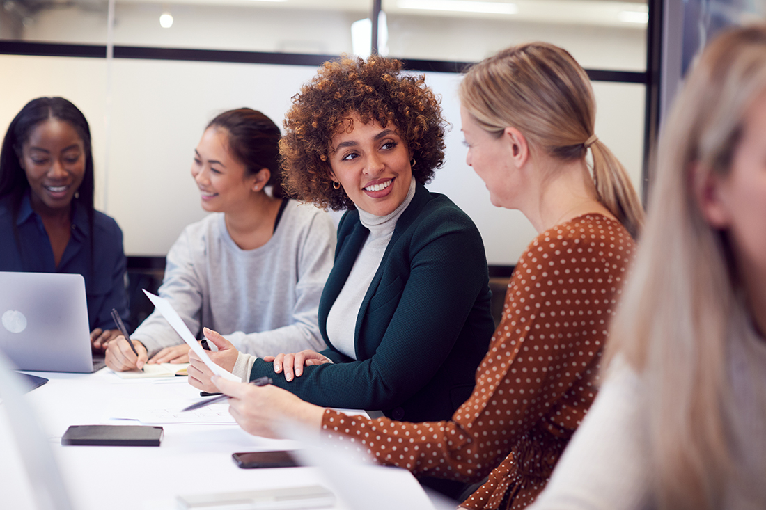 group of diverse business women at conference table
