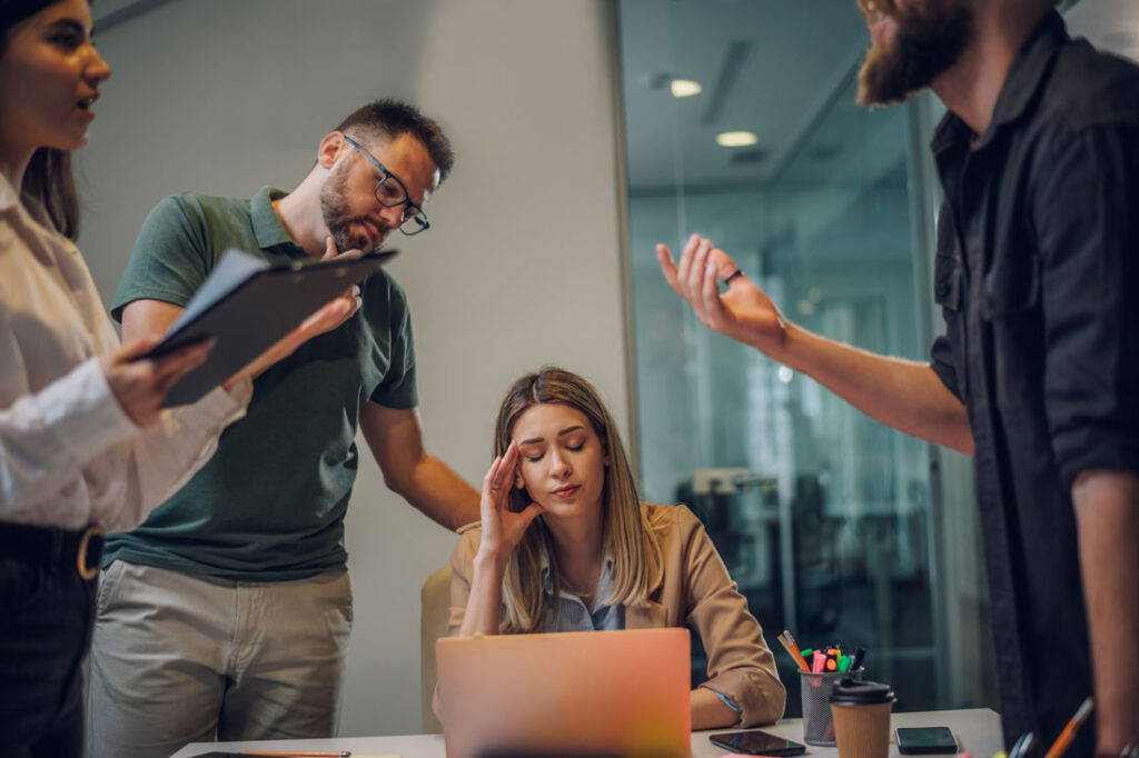 Woman in a meeting learning how to deal with annoying people at work