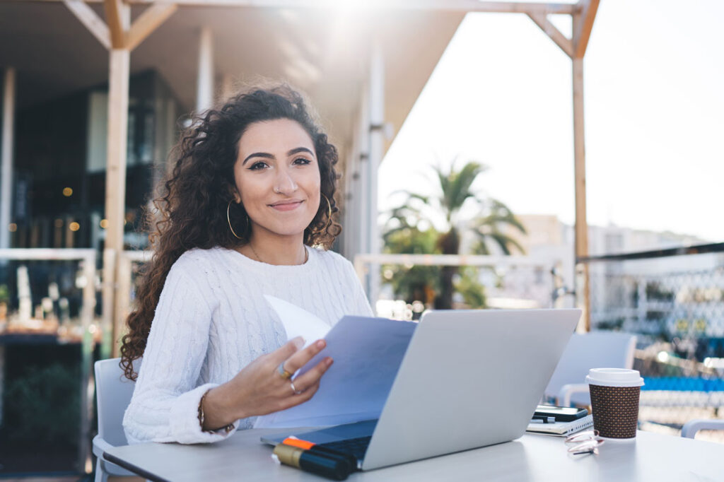 Woman on her computer outside learning how to use chatgpt