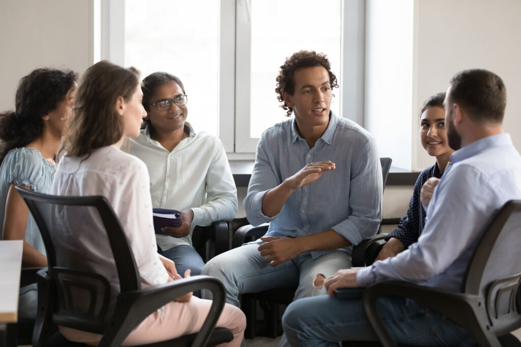 Boss talking to his employees on their level because he understands the difference between hustle culture vs quiet quitting