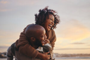 Happy Black couple smiling and laughing outside on a unique valentine's day date idea
