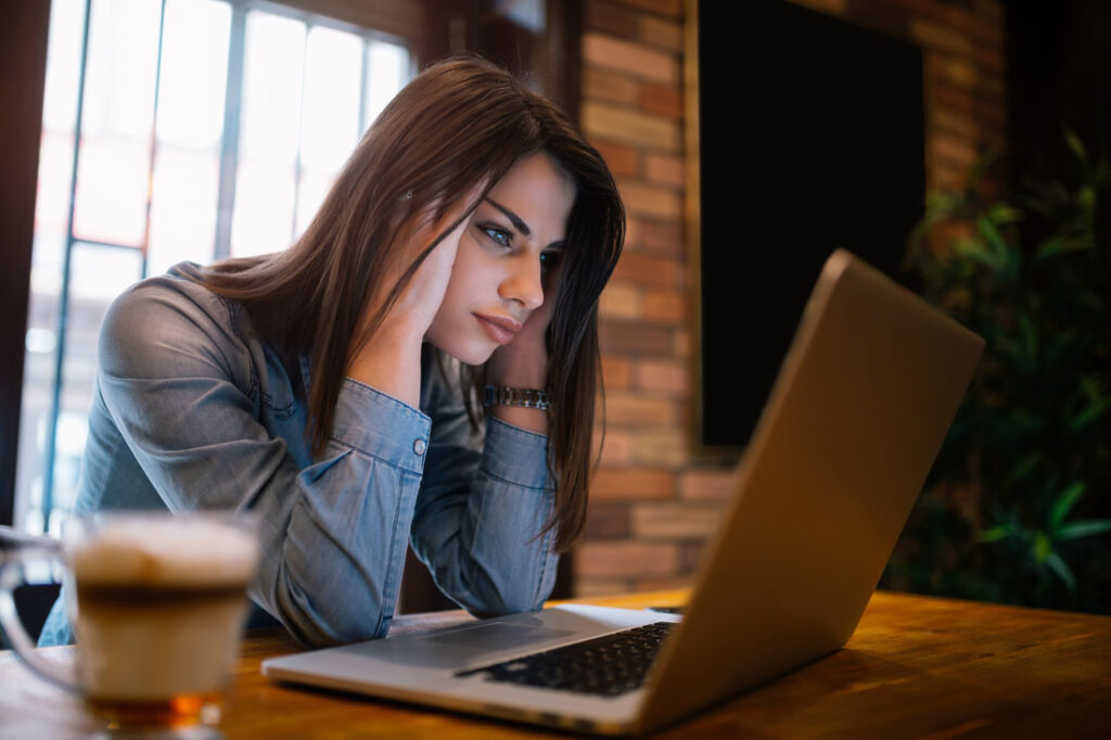 Frustrated woman working at her computer after learning about Google generative AI's effect on the SEO industry