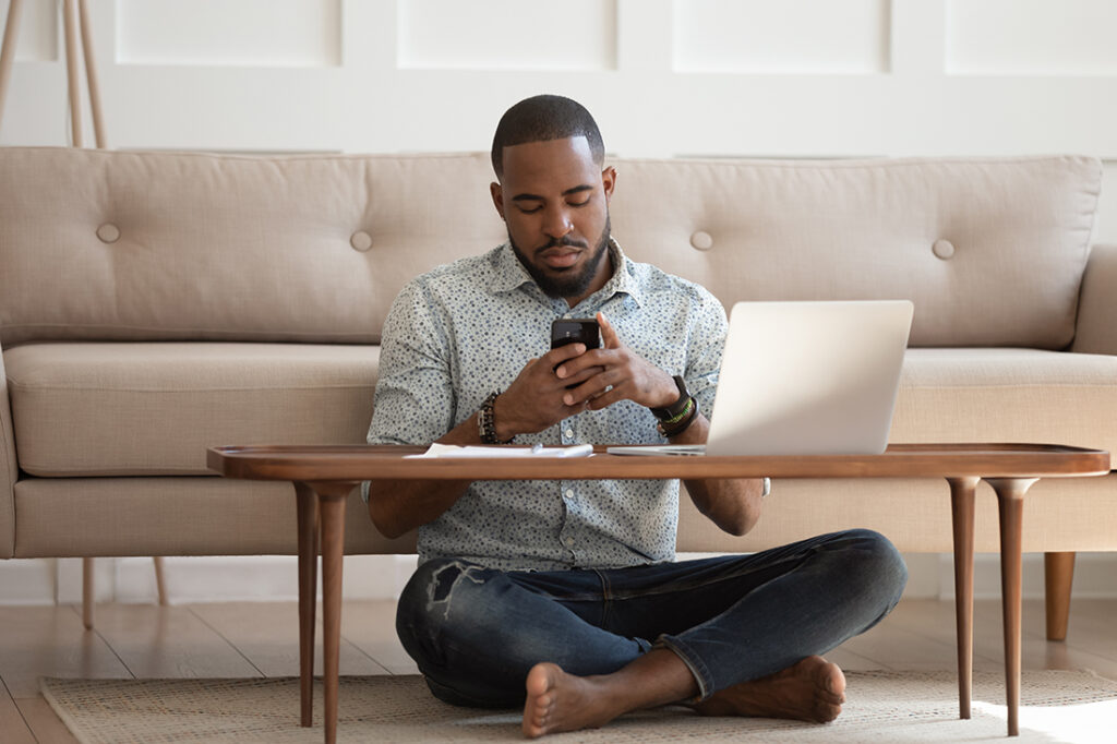 African American man staring at phone