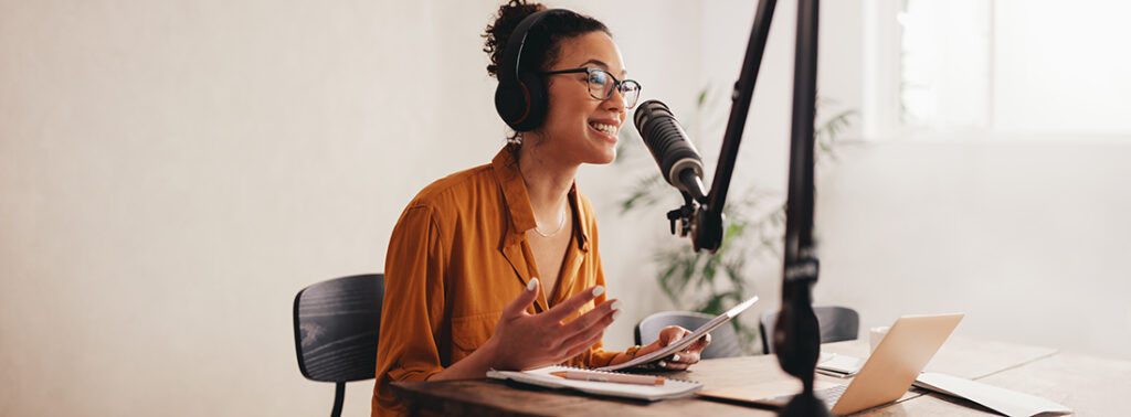 brunette haired woman speaking on a podcast