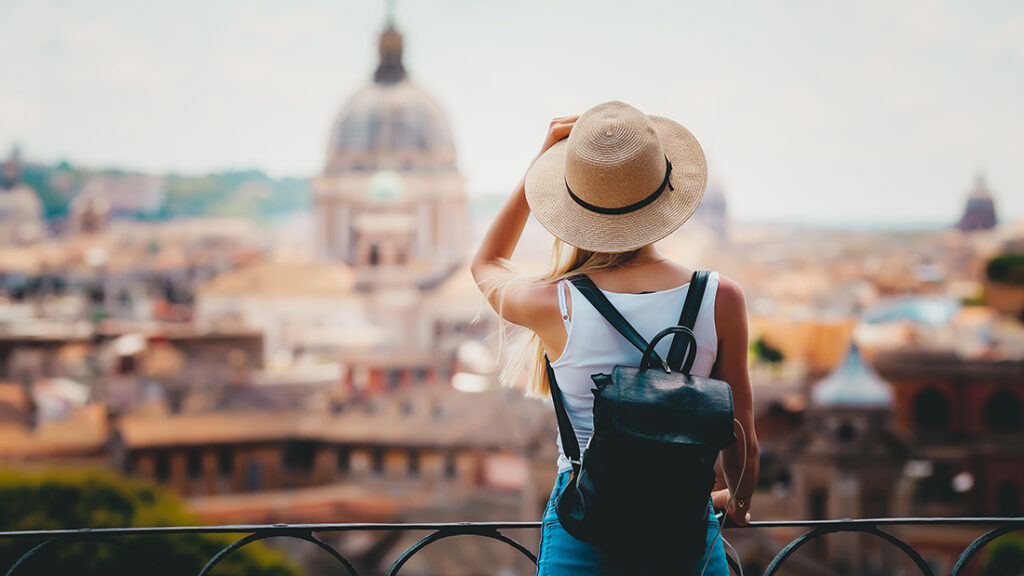 Woman in a hat with backpack traveling