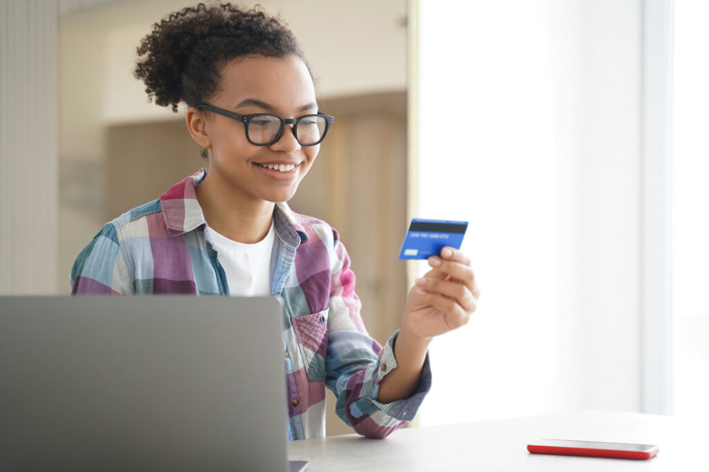 African American teenager looking at her debit card