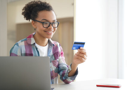African American teenager looking at her debit card