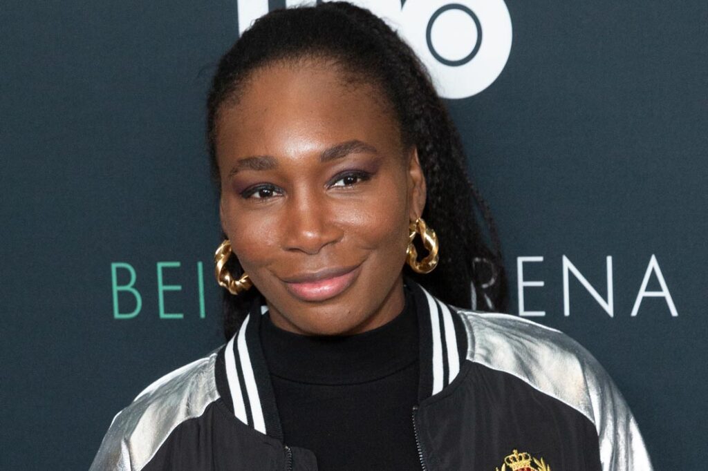 Celebrity franchises owner Venus Williams smiling in a black and silver jacket